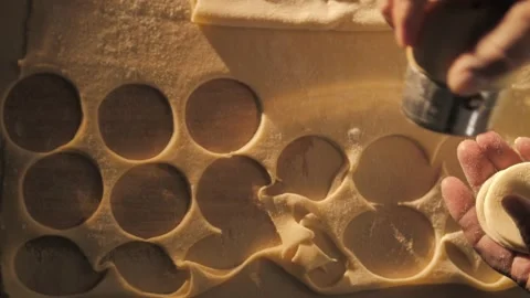 Close-up. Cutting out circles from raw dough. Stock Footage 168534398