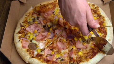 Close-up of cutting pizza into pieces Stock Footage 113011750