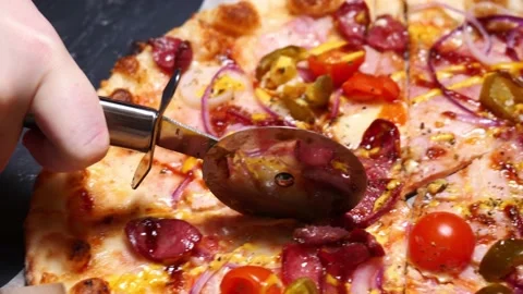 Close-up cutting pizza with a round cutter knife slow motion. camera movement Stock Footage 167819059