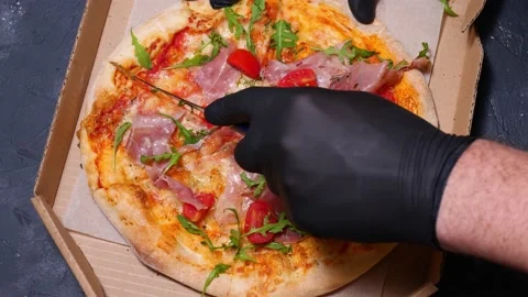 Close-up cutting pizza with a round cutter knife slow motion. camera movement Stock Footage 169006882