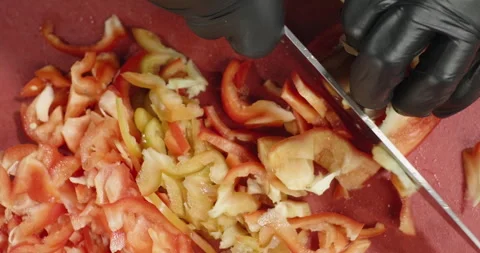 Close-up cutting red bell pepper. Male hands cut vegetables. Top view Stock Footage 260654990