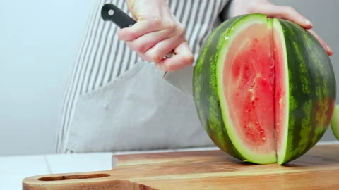 Close-up of cutting slices of watermelon in slow-motion in 4K. Stock Footage 145996014