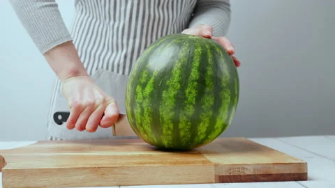 Close-up of cutting slices of watermelon in slow-motion in 4K. Stock Footage 145996399