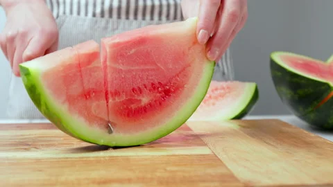 Close-up of cutting slices of watermelon in slow-motion in 4K. Stock Footage 145996483