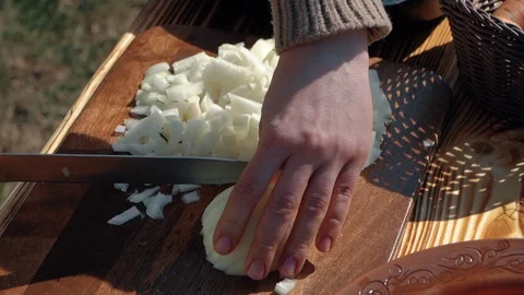 Close-up cutting slicing onion on a table kitchen preparing healthy food Stock Footage