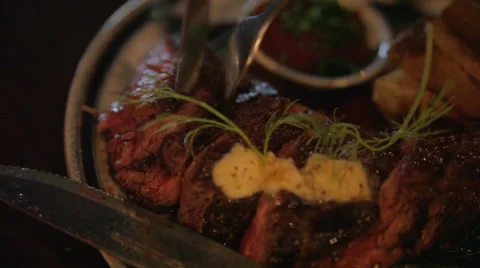 Close up of cutting into steak dish in restaurant Stockbeeldmateriaal 42429331