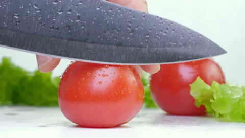A close up of cutting a tomato with a knife. Stock Footage 88336763