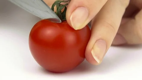 Close-up of cutting a tomato on a white background Stock Footage 83055458