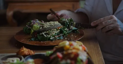 Close-up of cutting vegan calzone filled with lots of vegetables and greens Stock Footage 282963043