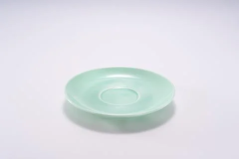 Close-up of cyan warm ceramic texture coaster and ceramic plate on white ba.. Stock Photos