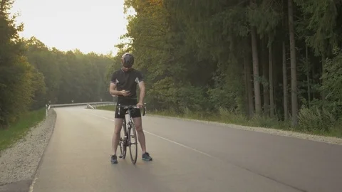 Close-up of cyclist checking his mobile phone on the ride Stock Footage 74544592