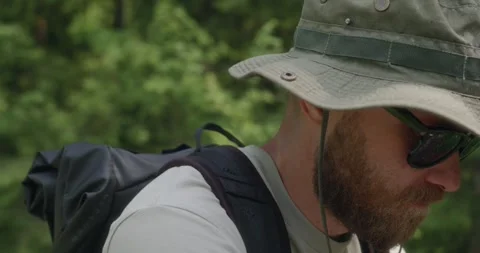 Close-up of cyclist looking down in forest light Stock Footage 311934194