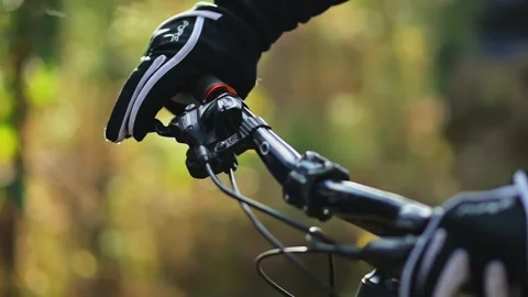 Close-up of a cyclist's hand in a glove on a mountain bike handlebar. Stock Footage 330169238
