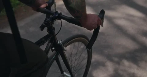 Close-up of cyclists hands on handlebars while riding Stock Footage 312354741
