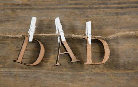 Close up of dad text hanging on string Stock Photos