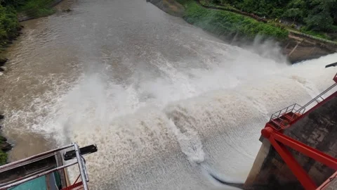 Close-up of dam flood discharge, muddy water forcefully gushing down with turbul Video stock 315569097