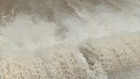 Close-up of dam releasing massive white water, foamy splash and roaring flood. Video stock 315569058