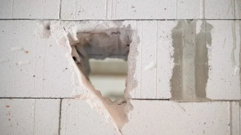 Close-up damage to an aerated concrete wall. Cutting a doorway in a thick wall Stock Footage 234877953