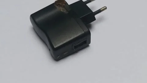 Close-up of a damaged black power adapter with a plastic casing Video stock 336472915