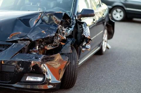 Close-up of damaged car part after accident showing broken metal and scratche Stock Photos