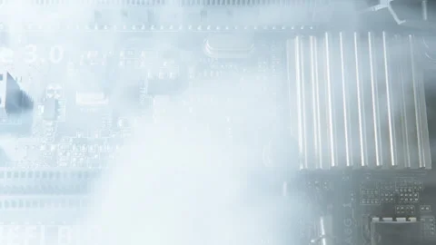 Close-up of a damaged computer motherboard emitting smoke, suggesting hardw.. Stock Footage 311336206