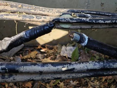 Close up of damaged high voltage underground power cable severed . Stock Photos