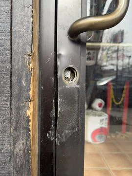 Close-Up Of Damaged Storefront Door Lock And Handle Showing Broken Keyhole .. Photos