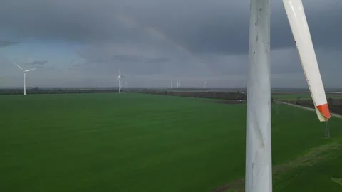 Close-up of a damaged wind turbine blade with a rainbow in the cloudy sky Stock-Footage 307597830