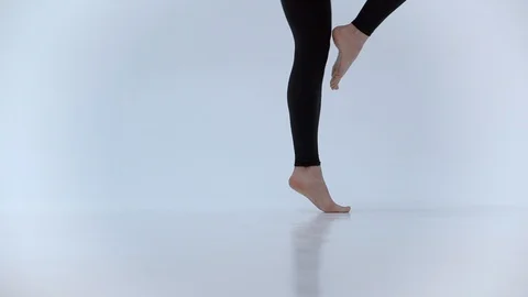 Close up of a dancer's feet as she practices point exercises, slow motion. Stock Footage 103455480