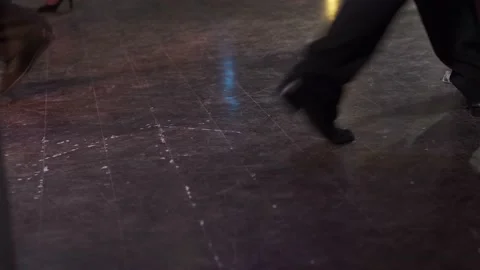 Close-up dancers legs performing tango in dark hall. Video stock 169491664