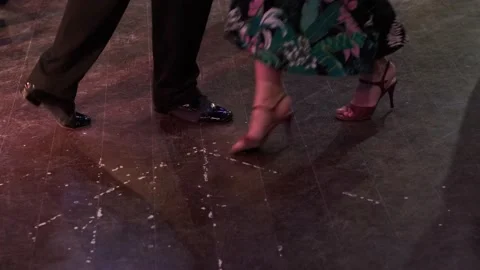 Close-up dancers legs performing tango in dark hall. Video stock 169491776
