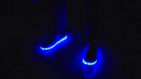 Close up of the Dancing feet - electronic lighting shoes changing colors Stock Footage 123214549