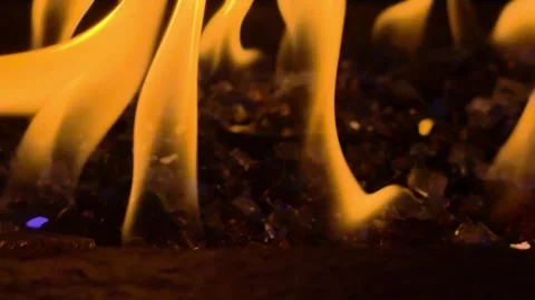 Close Up of Dancing Flames Over Decorative Fire Glass in Modern Gas Fire Pit Stock Footage 338366524
