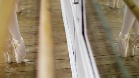 Close up, in dancing hall, Young ballerinas in purple leotards perform pas de Stock Footage 89148197