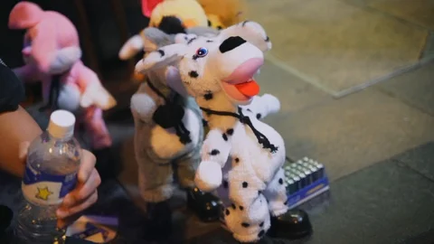 Close up of dancing toys being sold by a street vendor Stock Footage 99485019