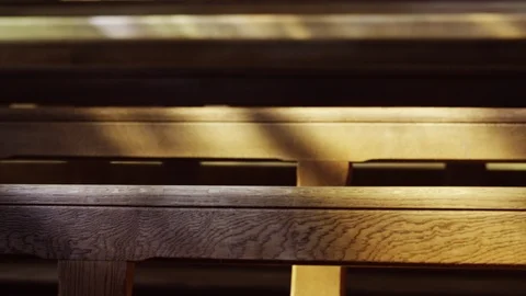 Close up dappled light through stained glass window on pews Stock Footage 114401855