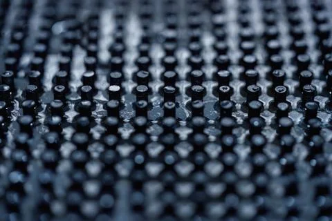 Close up of dark black peg repeating pattern Stock Photos