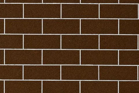 Close up of a dark brown brick wall with white mortar lines Stock Photos