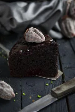 Close up dark chocolate cake slice on wooden planks Stock Photos