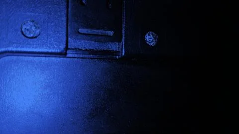 Close-up of a dark computer keyboard with blue backlight. Modern tech workspace Stockfoto's