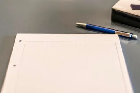 Close up of dark conference table pen, paper sheet and blurry background Stock Photos