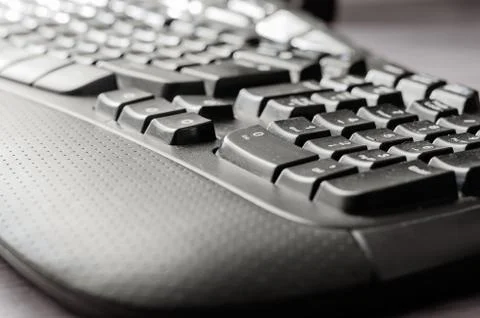 Close-up of a dark dusted computer keyboard. Stock Photos