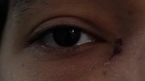 Close up of dark eyes looking in different directions and different blink rates 動画素材 126946723