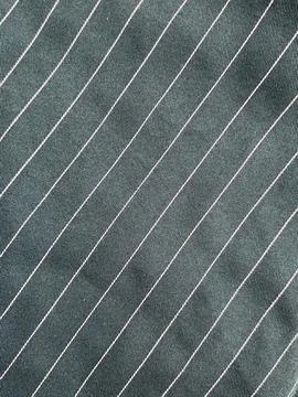 Close-up of dark fabric with diagonal white stripes. Stock Photos