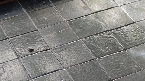 Close-up of Dark Gray Square Slate Tiles in Grid Pattern Under Natural Sunlight Stock Footage 344746773