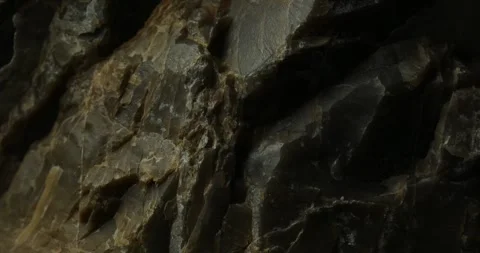 Close-Up of Dark Layered Rock with Jagged Edges Stock Footage 291944967