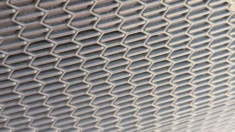 Close-up of a dark metal expanded mesh grille pattern Stock Photos