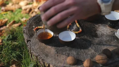 Close-up. dark puerh tea master pours into bowls for tea. chinese ceremony Stock Footage 229859405