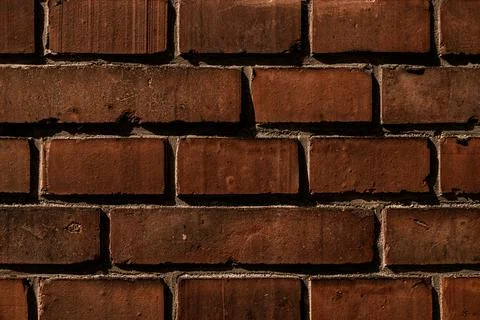 Close-up dark red brick wall. Abstract background pattern Stock Photos