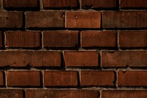 Close-up dark red brick wall texture. Abstract background pattern Foto stock